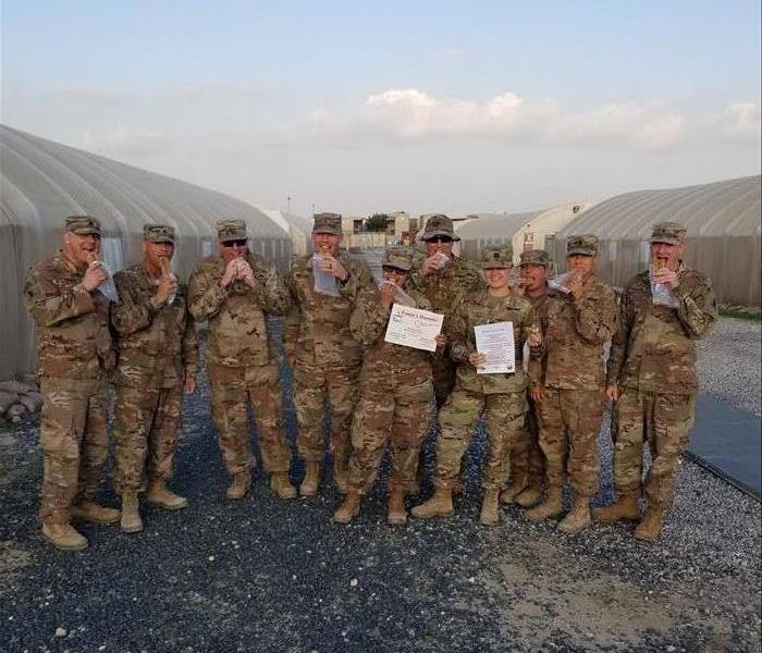 Soldiers receiving care package of Paula's Donuts from Blue Star Mothers.